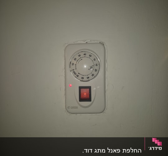 טיימר חשמלי עם מתג על קיר